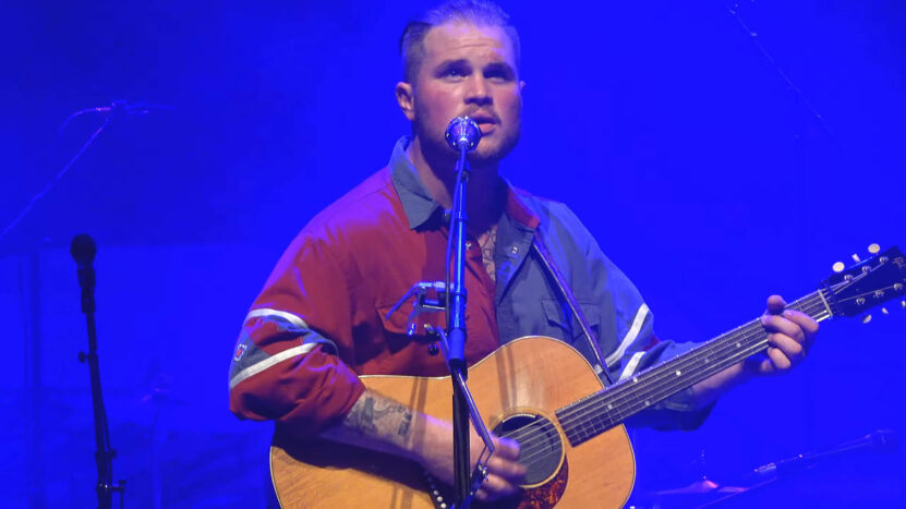 Musician Zach Bryan live performance at a concert in